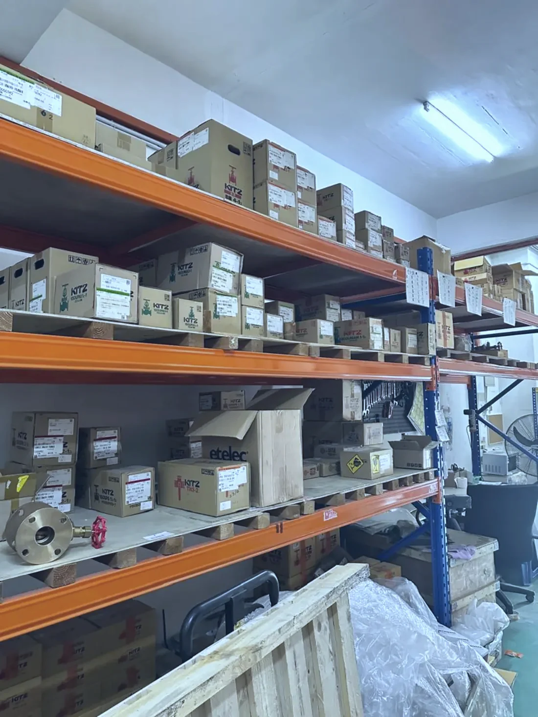 Shelving runs of boxed valve stock inside the Optimus Distributor warehouse